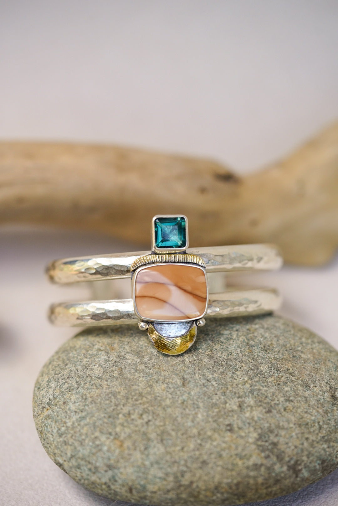 statement cuff with jasper and blue fluorite on a river rock