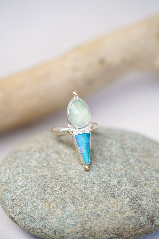 Silver ring with opal and chalcedony on a piece of driftwood