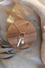 Load image into Gallery viewer, Gold necklace with pearl, opal and starburst shape pendant on a wooden coaster