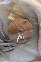 Load image into Gallery viewer, Gold necklace with a pendant on a wooden coaster