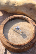 Load image into Gallery viewer, Silver ring with a vintage component design next tow two baguette diamonds in a wooden box on a stone surface