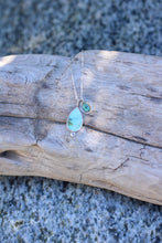 Load image into Gallery viewer, Turquoise colored stone teardrop pendant necklace on a piece of driftwood with a natural background