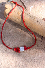 Load image into Gallery viewer, Necklace with red coral beads and a coin pearl on a stone surface
