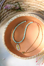 Load image into Gallery viewer, Necklace with a turquoise and sunstone beads and a pendant on a woven surface