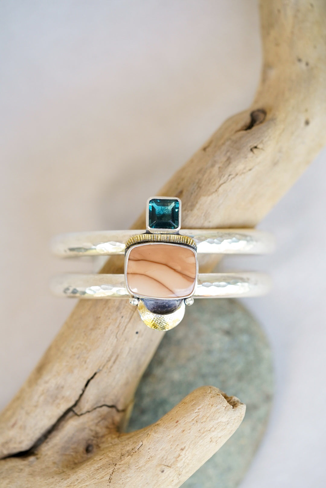 statement cuff with jasper and blue fluorite on a piece of driftwood