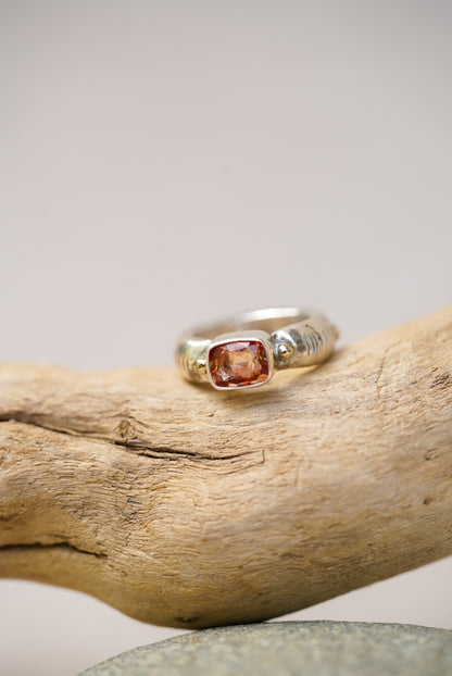 Sunstone silver ring on a piece of driftwood