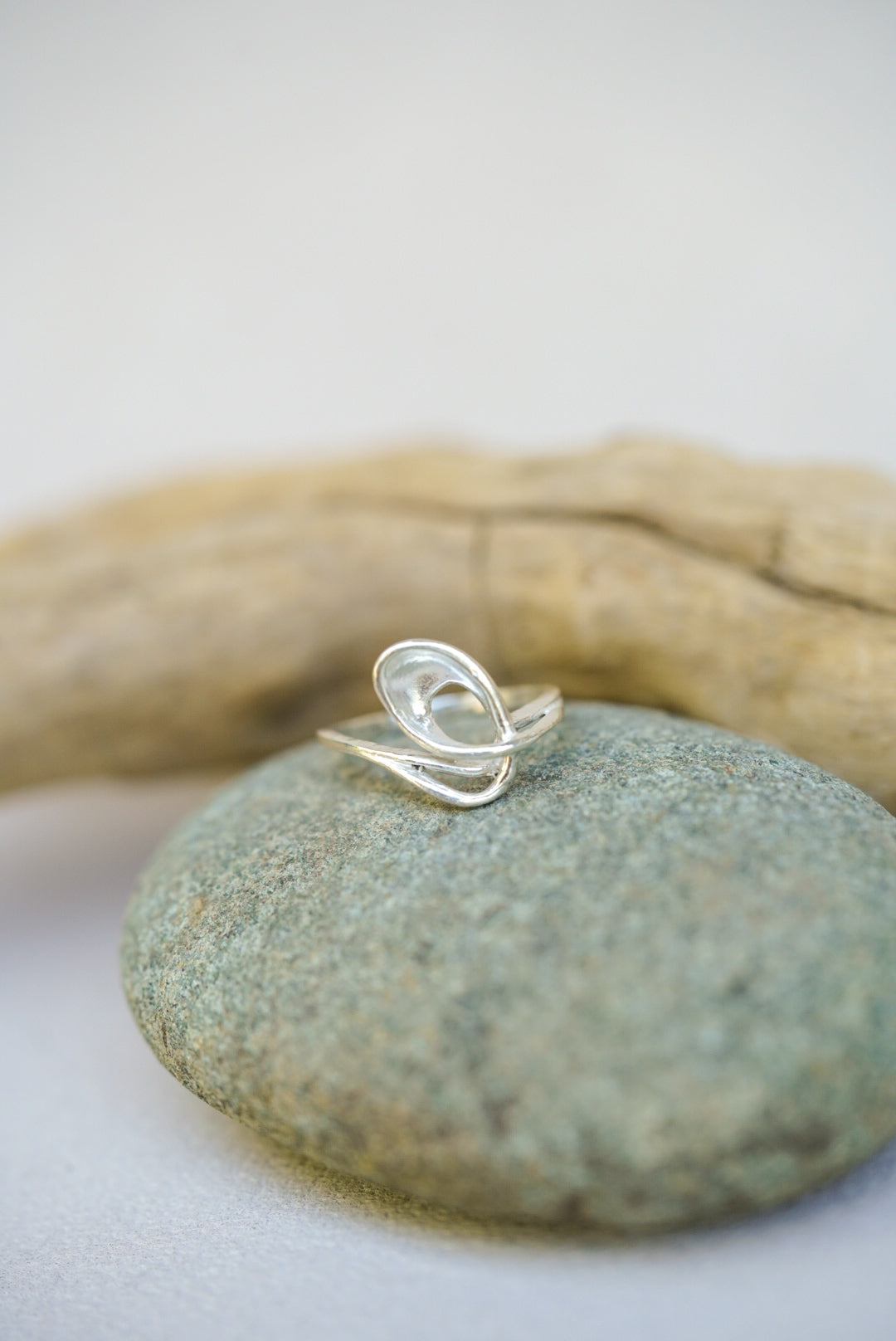 Silver ring on a stone with natural background