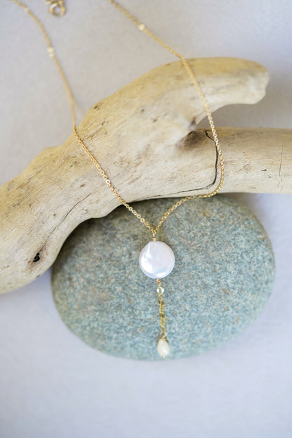 Necklace with a pendant on a piece of driftwood and stone