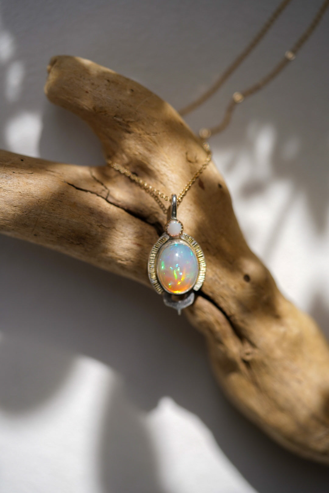 Opal pendant on a piece of driftwood