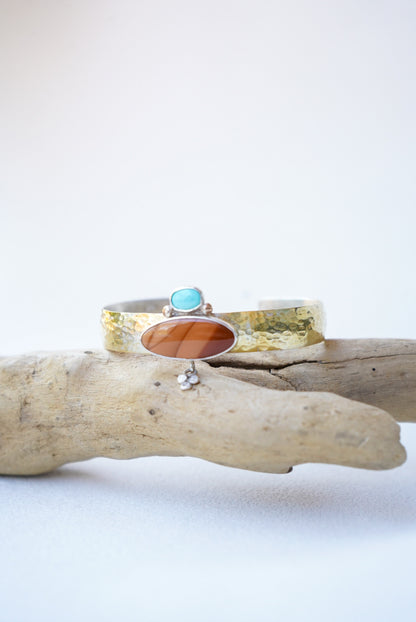 statement cuff with jasper and turquoise on a piece of driftwood