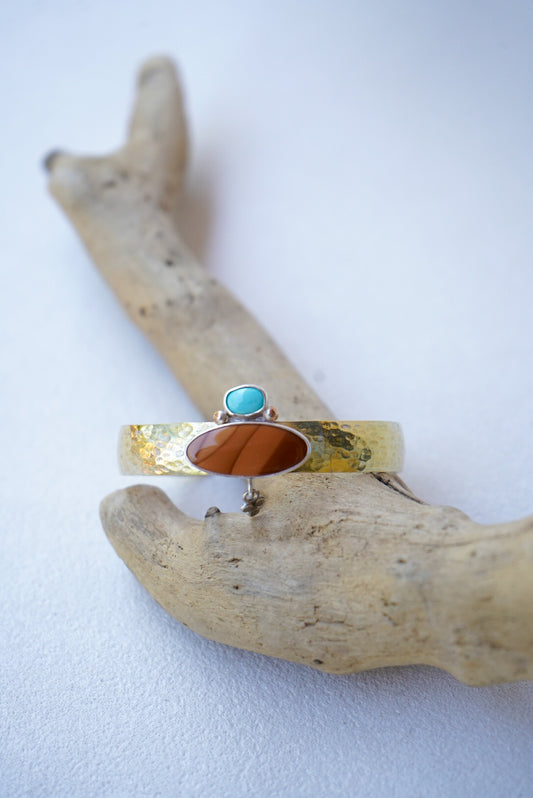 statement cuff with jasper and turquoise on a piece of driftwood