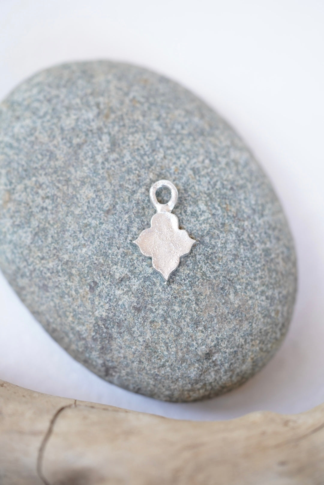 temple charm in silver on a rock