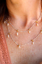 Load image into Gallery viewer, Necklace with pearls and gold accents worn by a person
