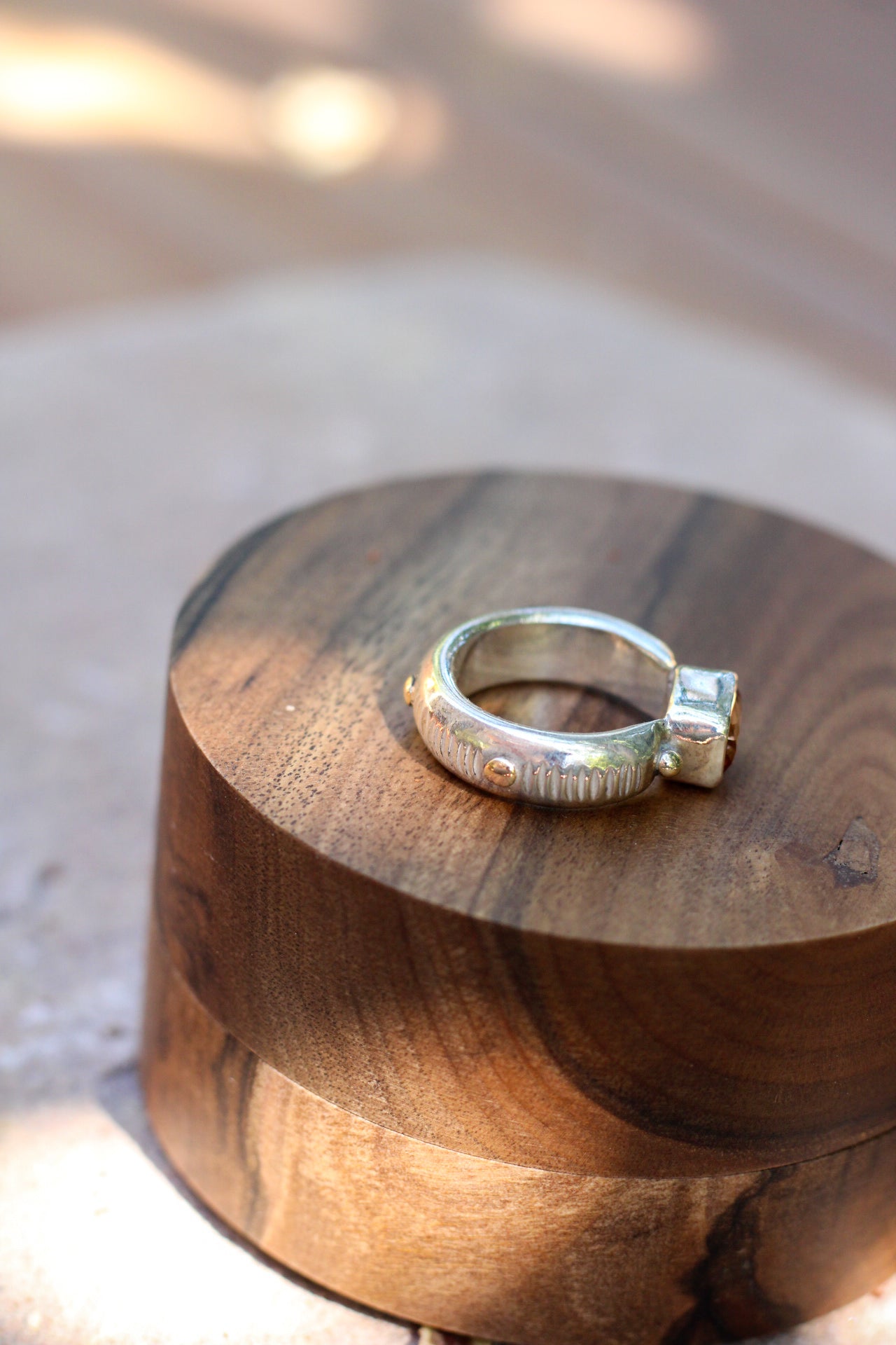 Silver ring on a wooden surface