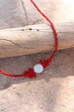Load image into Gallery viewer, Necklace with red coral beads and a coin pearl on a stone surface
