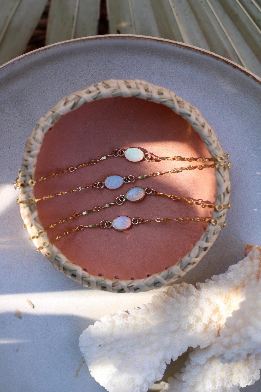 Four gold bracelets with opals